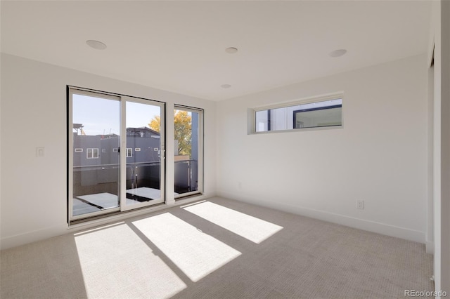 unfurnished room with light colored carpet