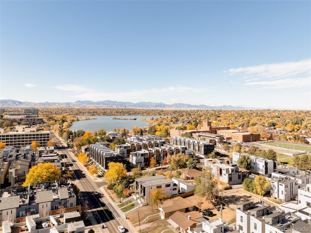 drone / aerial view with a water and mountain view