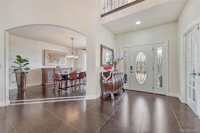 3035 Blodgett Dr, Colorado Springs, CO 80919 - entryway with a chandelier, arched walkways, baseboards, and a towering ceiling