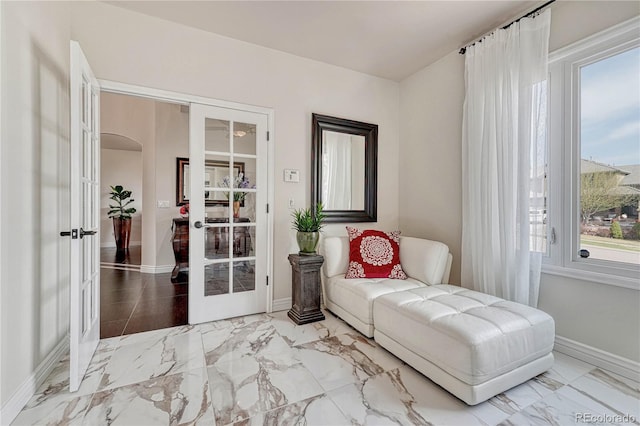 3035 Blodgett Dr, Colorado Springs, CO 80919 - living area featuring french doors, marble finish floor, and baseboards