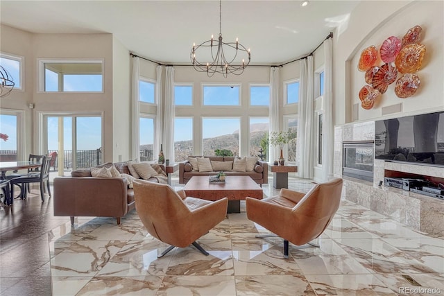 3035 Blodgett Dr, Colorado Springs, CO 80919 - living room with a chandelier, recessed lighting, a high ceiling, a tile fireplace, and marble finish floor