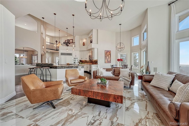 3035 Blodgett Dr, Colorado Springs, CO 80919 - living room with a high ceiling, a chandelier, and a wealth of natural light