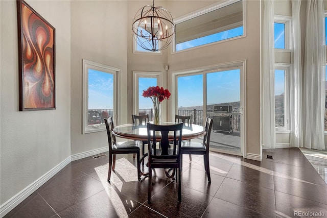 3035 Blodgett Dr, Colorado Springs, CO 80919 - dining room featuring visible vents, baseboards, a chandelier, and a high ceiling