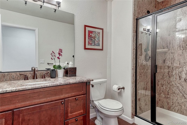 3035 Blodgett Dr, Colorado Springs, CO 80919 - full bathroom with a shower stall, vanity, baseboards, and toilet