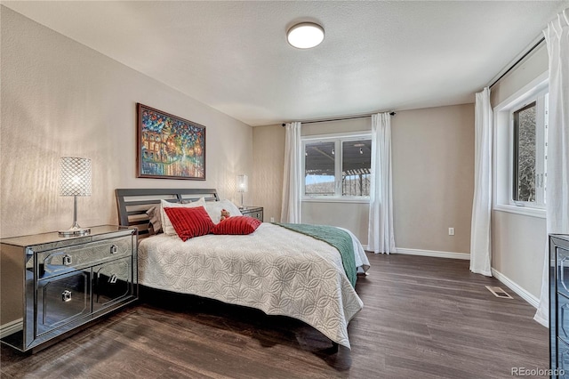 3035 Blodgett Dr, Colorado Springs, CO 80919 - bedroom with dark wood-type flooring, visible vents, and baseboards