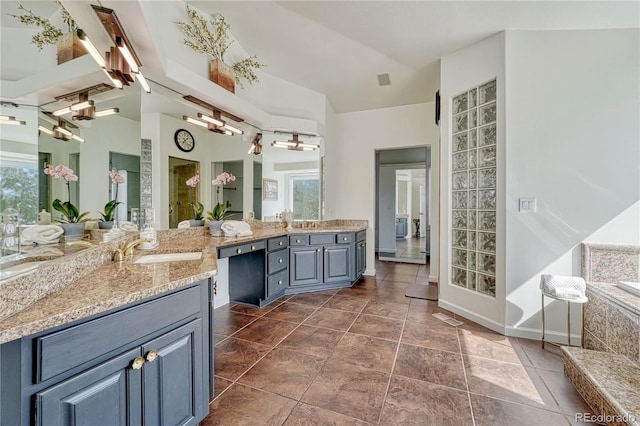 3035 Blodgett Dr, Colorado Springs, CO 80919 - full bath with a healthy amount of sunlight, vanity, baseboards, and visible vents