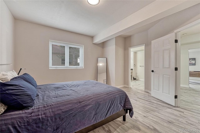 3035 Blodgett Dr, Colorado Springs, CO 80919 - bedroom featuring light wood-style floors, baseboards, and connected bathroom