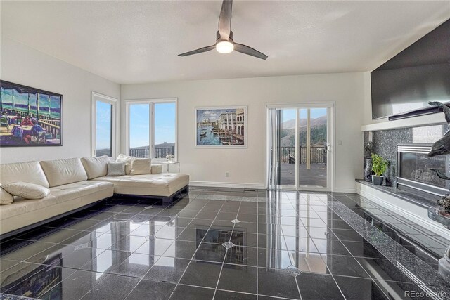 3035 Blodgett Dr, Colorado Springs, CO 80919 - living room with baseboards, a ceiling fan, granite finish floor, and a fireplace