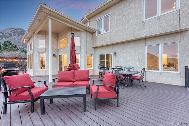3035 Blodgett Dr, Colorado Springs, CO 80919 - deck featuring outdoor dining space, grilling area, a mountain view, and an outdoor hangout area