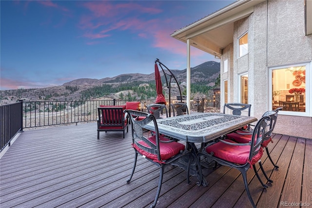 3035 Blodgett Dr, Colorado Springs, CO 80919 - deck at dusk with a mountain view and outdoor dining area
