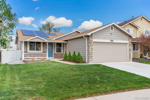 13244 Quivas St, Denver, CO 80234 - view of front of house with a porch, stone siding, a garage, roof mounted solar panels, and driveway