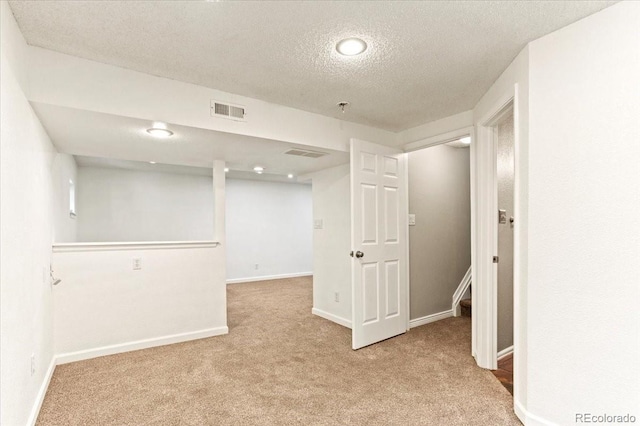 13244 Quivas St, Denver, CO 80234 - finished basement with a textured ceiling, light colored carpet, and baseboards
