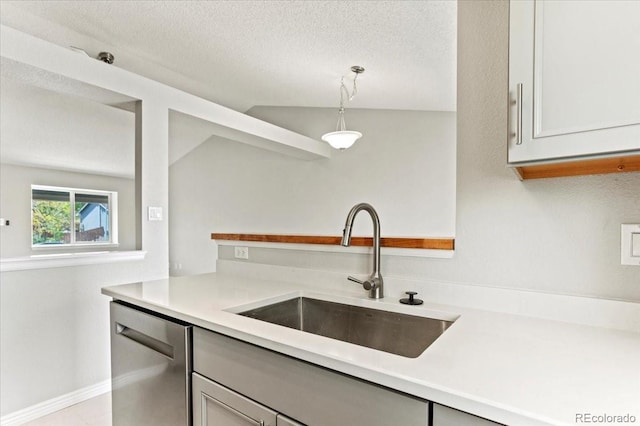 13244 Quivas St, Denver, CO 80234 - kitchen with a sink, stainless steel dishwasher, light countertops, vaulted ceiling, and hanging light fixtures