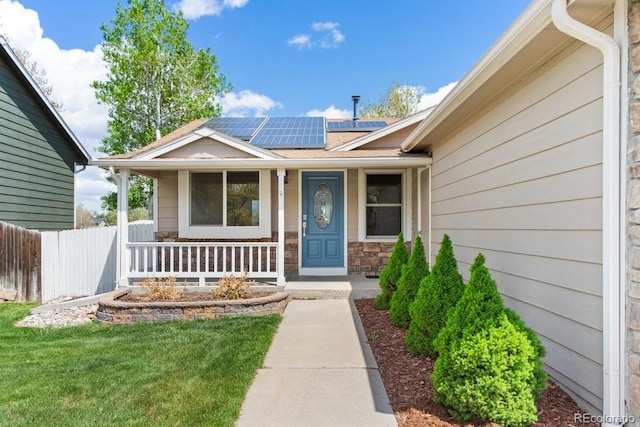 13244 Quivas St, Denver, CO 80234 - doorway to property featuring covered porch, solar panels, and roof with shingles
