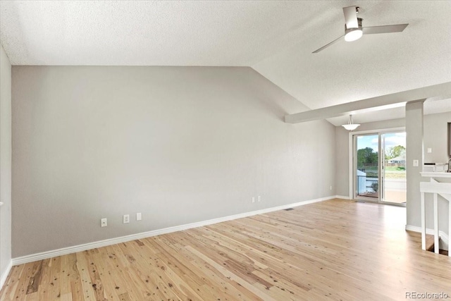 13244 Quivas St, Denver, CO 80234 - unfurnished living room with ceiling fan, wood finished floors, vaulted ceiling, a textured ceiling, and baseboards