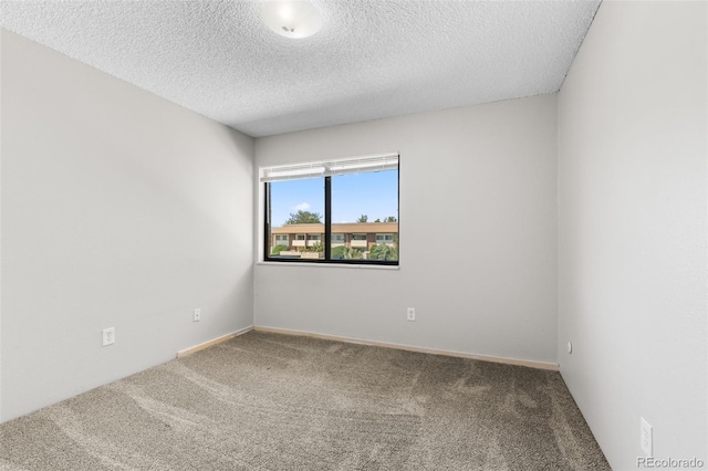 carpeted spare room featuring a textured ceiling