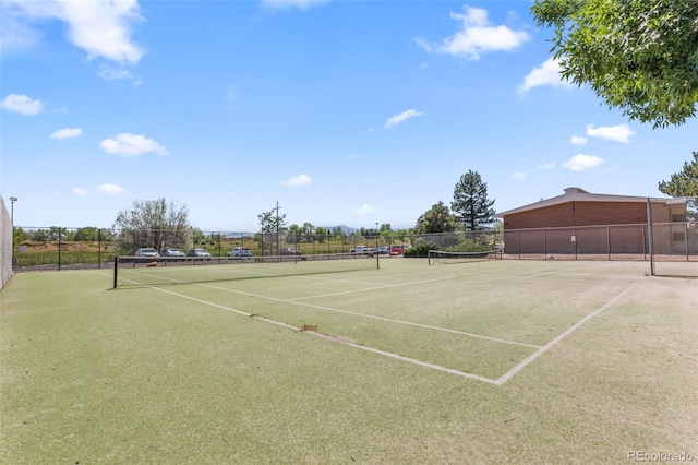 view of tennis court featuring fence