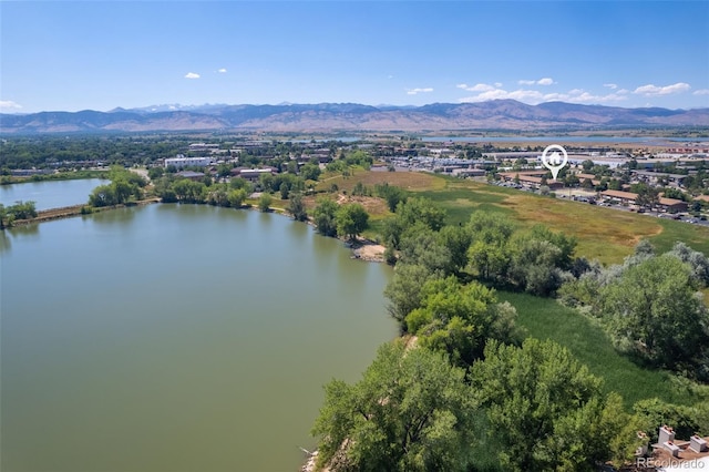 drone / aerial view with a water and mountain view