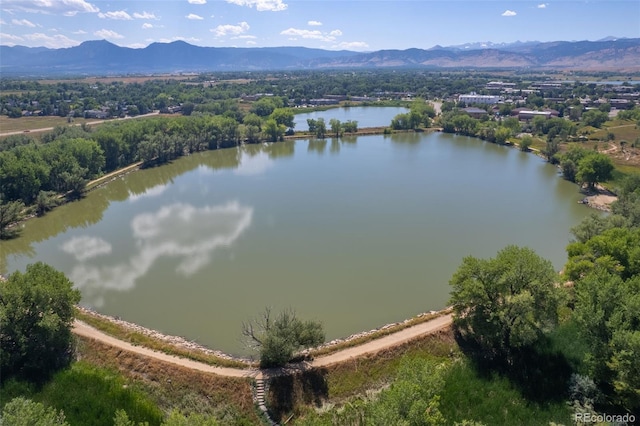 birds eye view of property with a water and mountain view