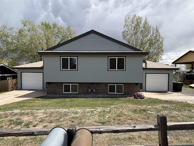 split level home with an attached garage and concrete driveway