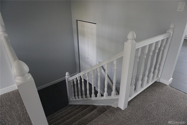 stairway with carpet and baseboards