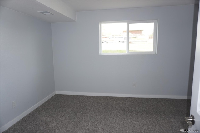 carpeted empty room featuring baseboards