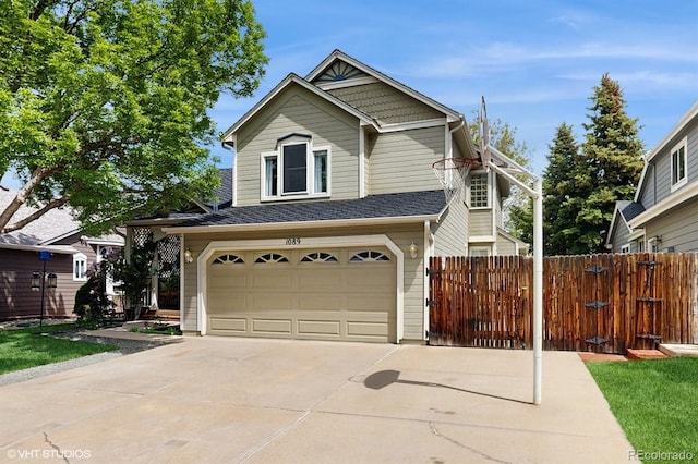 view of front of home with a garage, concrete driveway, and fence