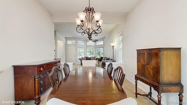 dining space with a chandelier, baseboards, and ceiling fan