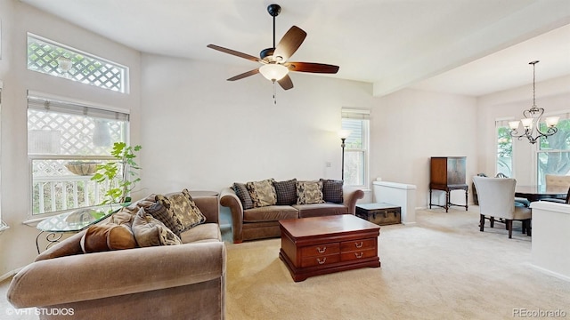 living area with a chandelier, ceiling fan, and light carpet