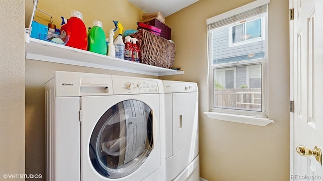 clothes washing area with washing machine and dryer