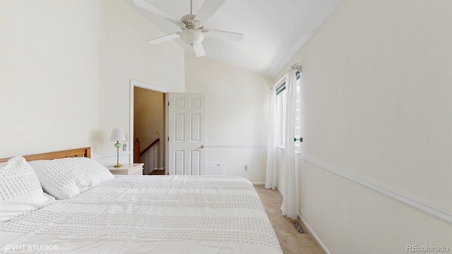 bedroom featuring high vaulted ceiling, light carpet, and a ceiling fan