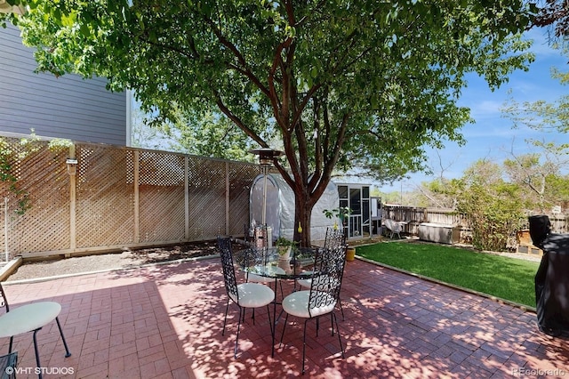 view of patio with a fenced backyard and outdoor dining space