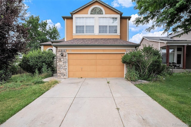 2786 S Cathay Way, Aurora, CO 80013 - traditional home featuring an attached garage, concrete driveway, stone siding, a shingled roof, and a front yard