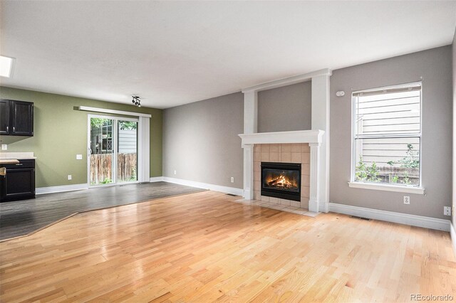 2786 S Cathay Way, Aurora, CO 80013 - unfurnished living room with light wood finished floors and a fireplace