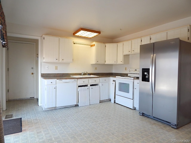 kitchen with white cabinets, white appliances, and sink