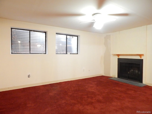 unfurnished living room featuring ceiling fan and carpet