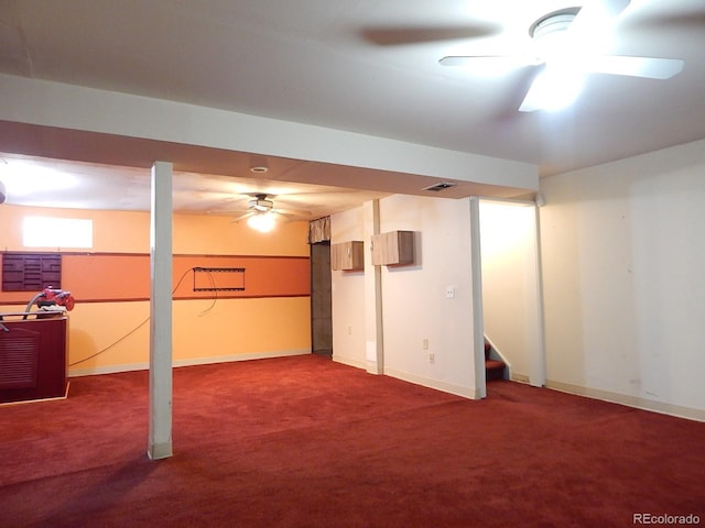 basement featuring carpet and ceiling fan