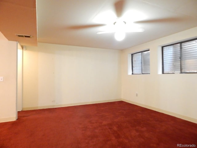 spare room with ceiling fan and carpet