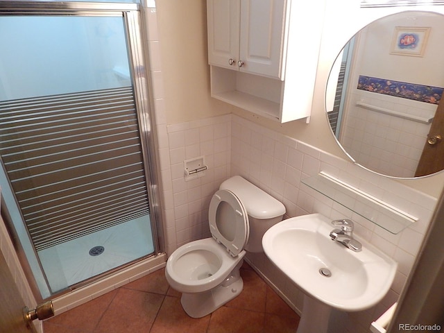 bathroom featuring tile patterned flooring, sink, tile walls, toilet, and walk in shower