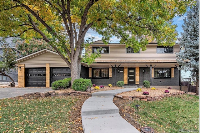 5720 E Caley Ave, Centennial, CO 80111 - traditional-style house featuring a porch, asphalt driveway, brick siding, and an attached garage