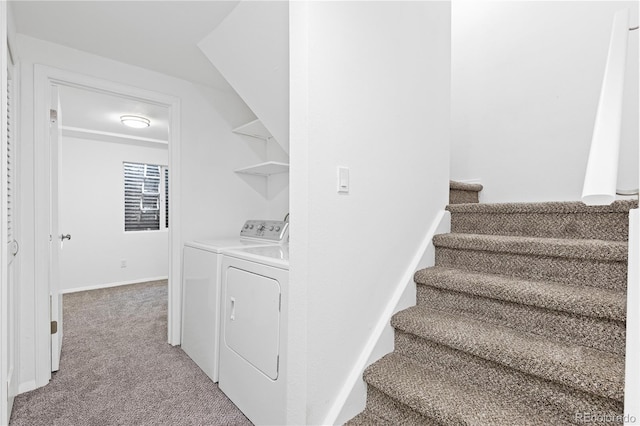 laundry area with laundry area, washing machine and dryer, baseboards, and carpet flooring