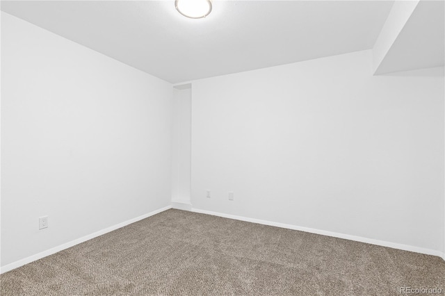 carpeted empty room with baseboards