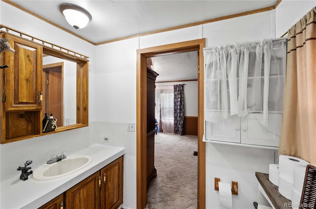 bathroom with vanity, a textured ceiling, and ornamental molding