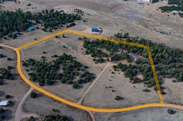 birds eye view of property with a rural view