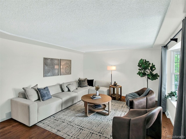 6943 Ingalls St, Arvada, CO 80003 - living area with wood finished floors, a textured ceiling, and baseboards