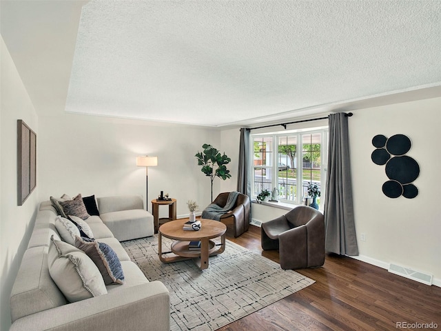 6943 Ingalls St, Arvada, CO 80003 - living area featuring a textured ceiling, wood finished floors, and baseboards