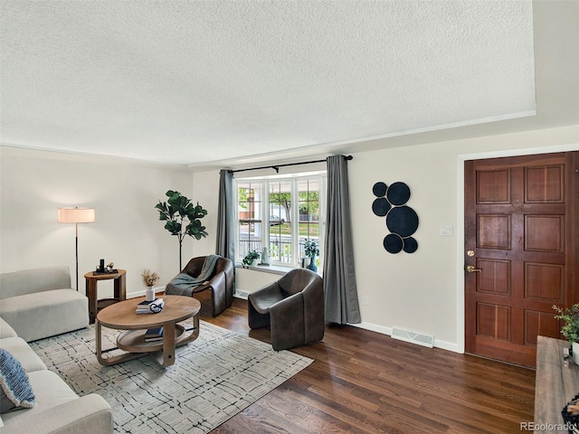 6943 Ingalls St, Arvada, CO 80003 - living area with a textured ceiling, dark wood-type flooring, and baseboards