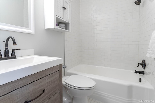 full bathroom featuring toilet, vanity, and tiled shower / bath