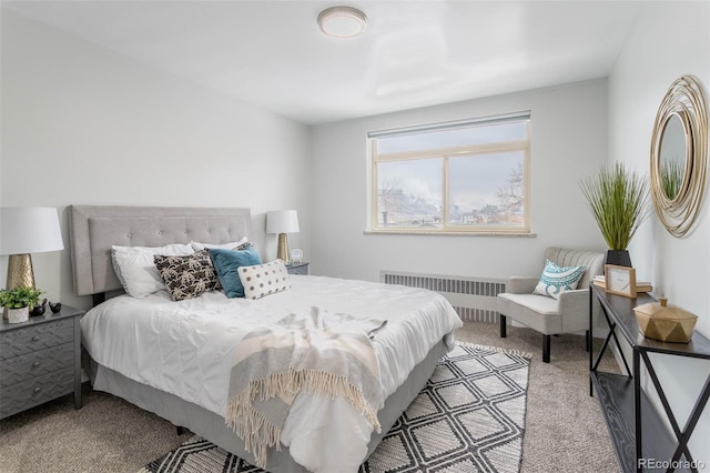 bedroom with light carpet and radiator heating unit