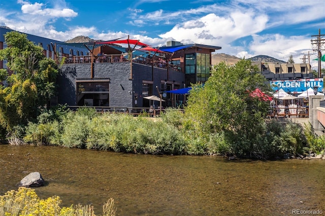 exterior space with a water and mountain view